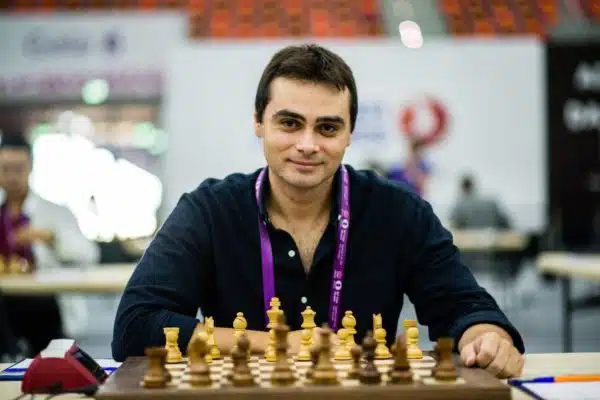 Ntirlis nikolaos is sitting in front of a chess board